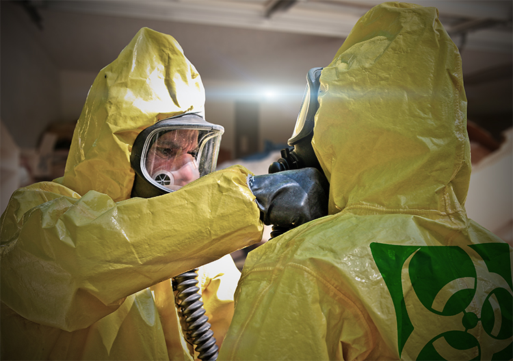 Biohazard cleaners dressed in full PPE and respirators prepare for cleaning an extreme hoarding case.
